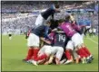  ?? DAVID VINCENT — THE ASSOCIATED PRESS ?? Paul Pogba, top, celebrates with teammates after France’s Kylian Mbappe scored a goal during France’s 4-3 round-of-16 victory over Argentina on Saturday.