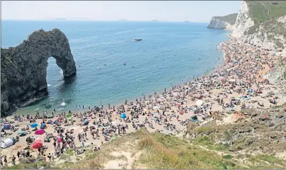  ??  ?? But it was a different scene in Dorset yesterday as thousands crammed onto Durdle Door beach to enjoy the good weather