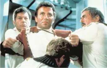  ??  ?? Dr. McCoy ( DeForest Kelley, left) and Scotty ( James Doohan) restrain a hot- tempered Admiral Kirk ( William Shatner) in “Star Trek II: The Wrath of Khan.”
| PARAMOUNT PICTURES