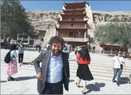  ?? PHOTOS BY ZHU XINGXIN / CHINA DAILY ?? Kumar Khadka pays a visit to the Mogao Grottoes in Dunhuang, Northwest China’s Gansu province.