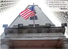  ?? — Reuters ?? A flag flutters in the wind outside the New York Stock Exchange.