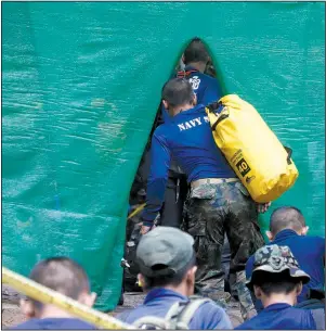  ?? AP/SAKCHAI LALIT ?? Rescuers arrive Sunday in Mae Sai, Thailand, near a cave where 12 boys and their soccer coach have been trapped since June 23.