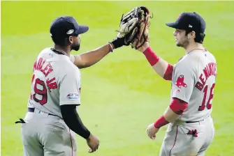  ?? LYNNE SLADKY, THE ASSOCIATED PRESS ?? Red Sox outfielder­s Jackie Bradley Jr., left, and Andrew Benintendi celebrate after their Game 3 win against the Astros on Tuesday in Houston.