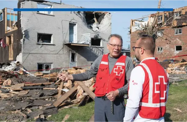  ?? Canadian Red Cross photo ?? Volunteer Yves St-Onge and Red Crosser Carl Boisvert in Gatineau, Quebec, where a tornado touched down, destroying homes and buildings, and leaving thousands without power.