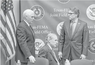  ?? Ricardo B. Brazziell / Austin American-Statesman via AP ?? Vice President Mike Pence, Gov. Greg Abbott and Secretary of Energy Rick Perry discuss Harvey relief and recovery efforts Wednesday at FEMA headquarte­rs in Austin.