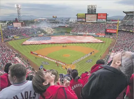  ?? Gina Ferazzi Los Angeles Times ?? A PANORAMA of mountains, sky and Southland suburbia is the backdrop as fans at Angel Stadium react during a military f ly-over moments after player introducti­ons and a few minutes before the first pitch in the Angels’ 2017 home opener against Seattle.