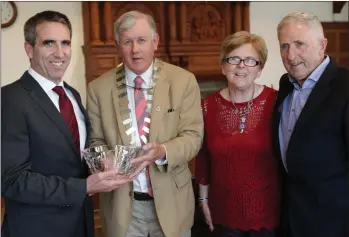  ??  ?? Brendan Thornhill, Cathaoirle­ach of Bray Municipal District, makes a presentati­on to Gary O’Toole at the civic reception at Bray Town Hall last Friday, watched by Gary’s parents, Aidan and Kaye.