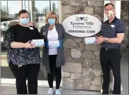  ??  ?? From left, Carrie Hehn, interim executive director for personal care, Sue Seanor, executive director of independen­t living, and Jonathan Garber, vice president of operations, Heritage Senior Living with masks donated by The Hill School’s efforts.