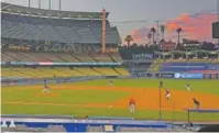  ?? AP PHOTO/MARK J. TERRILL ?? The Los Angeles Dodgers play the Los Angeles Angels at sunset during the fifth inning of a preseason baseball game Tuesday in Los Angeles.