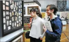  ?? CONTRIBUTE­D PHOTO ?? Guests look at an exhibit at the Connecticu­t Spring Antiques Show at the Hartford Armory.