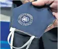 ??  ?? Mr Trump’s face mask was decorated with the presidenti­al seal