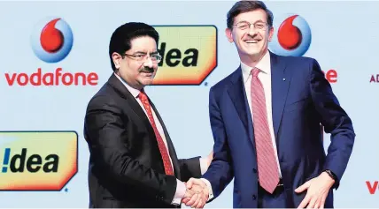  ??  ?? Kumar Mangalam Birla ( left), chairman of Aditya Birla Group, with Vittorio Colao, CEO of Vodafone, after announcing the merger