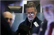  ?? RICHARD DREW — THE ASSOCIATED PRESS ?? Trader Ronald Madarasz works on the floor of the New York Stock Exchange Friday.