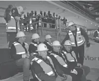  ??  ?? Milwaukee Bucks President Peter Feigin (right) and some fans who have held season tickets for 50 years gather Tuesday for the installati­on of the first seats in the new arena. The ticket holders are (back row, from left) Robert Dorf, Jon Dorf and Keith...