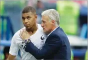  ?? AP PHOTO BY NATACHA PISARENKO ?? France’s Kylian Mbappe, left, is embraced by France head coach Didier Deschamps during 2018 soccer World Cup in the Nizhny Novgorod Stadium, in Nizhny Novgorod, Russia.