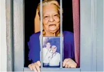  ?? — AP ?? Lionel Messi’s former neighbour Marta Rodriguez shows her autographe­d picture with the idol inside her home, on the same block that Messi grew up on in La Bajada, Rosario, Argentina.