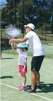  ??  ?? Sophie Emmerson (left) and coach Jamie Dunn have some fun serving water balloons to cool off during the clinic held at Drouin on Wednesday.