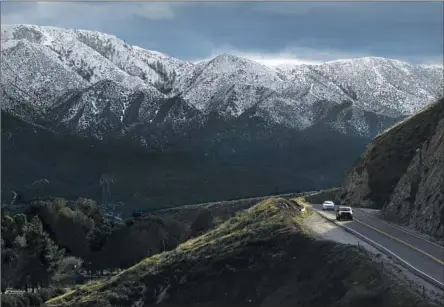  ?? Myung J. Chun Los Angeles Times ?? VEHICLES DRIVE along Soledad Canyon Road in Acton, in northern L.A. County, with a view of snowcapped mountains.