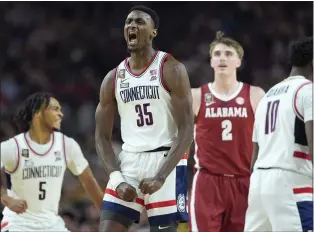  ?? AP PHOTO/BRYNN ANDERSON ?? UConn forward Samson Johnson celebrates a basket during the second half of the NCAA college basketball game against Alabama at the Final Four, Saturday, April 6, 2024, in Glendale, Ariz.