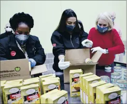  ?? ELIZABETH CONLEY — HOUSTON CHRONICLE VIA AP ?? From left, U.S. Reps. Sheila Jackson Lee, Alexandria Ocasio-cortez and Sylvia Garcia fill boxes at the Houston Food Bank on Saturday.