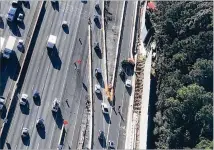  ?? DOUG TURNBULL/WSB SKYCOPTER ?? Three drivers crash, one is under the barrier. The I-285 ramp to Roswell Road was shut down Wednesday afternoon. Driving mistakes take police away from patrolling for crime.