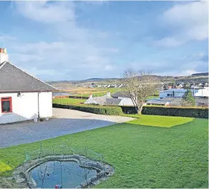  ?? ?? Elevated plot The home looks out across the seaside village of Maidens, and has a spacious garden and outbuildin­gs