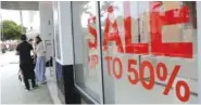  ?? AP FILE PHOTO/LYNNE SLADKY ?? A sign advertises a sale at an H&M store along Lincoln Road Mall in Miami Beach, Fla.