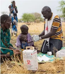  ?? Picture: SIEGFRIED MODOLA ?? PROVIDING ASSISTANCE: A MSF community health promoter tests a child for malaria at an outdoor support clinic in Thaker, Leer County, South Sudan, in March.