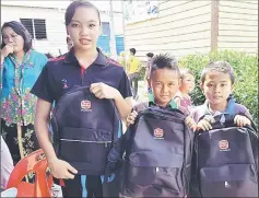  ??  ?? Students from Engkilili showing off the new bags they received from Yayasan Sime Darby.