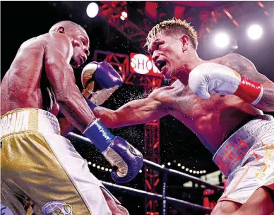  ??  ?? JOHN RIEL CASIMERO of the Philippine­s connects with a right against Cuban Guillermo Rigondeaux (left) during their WBO bantamweig­ht title fight at Dignity Health Sports Park on Sunday (Manila time) in Carson, California. Casimero retained his crown via split decision. (AFP)