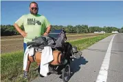  ?? BILL LACKEY /STAFF ?? Joe Hall pauses on his journey along U.S. 40 between South Vienna and Springfiel­d on Thursday.