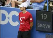  ?? NICK WASS — THE ASSOCIATED PRESS ?? In this Friday photo, a ball boy stands next to the serve clock during a match between Kei Nishikori, of Japan, and Alexander Zverev, of Germany, at the Citi Open tennis tournament in Washington.