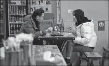  ?? WAN XIANG / XINHUA ?? Chen Lei (left) and his wife Zhang Liuqing, who both work as real estate managers, eat a meal at a small restaurant in Nanchang, Jiangxi province, in December.