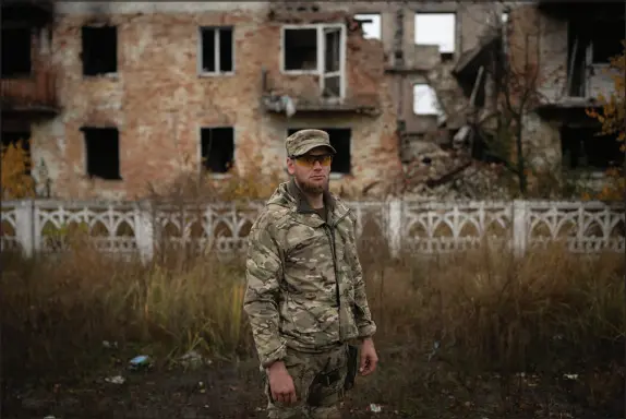  ?? BRAM JANSSEN / ASSOCIATED PRESS ?? Oleksii Yukov, a Ukrainian body collector, is photograph­ed Oct. 24, 2023, in the Sloviansk region of Ukraine. He tells the mothers of those killed to talk about their dead children, so they will be remembered.