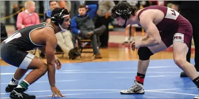  ?? Photos by Jerry Silberman / risportsph­oto.com ?? Woonsocket senior Rogelio Gonzalez (left) and La Salle’s Jacob Harrison (right) engaged in the best finals match at Saturday’s state tournament. Harrison earned a 3-1 overtime victory after he countered Gonzalez’ ankle pick attempt.