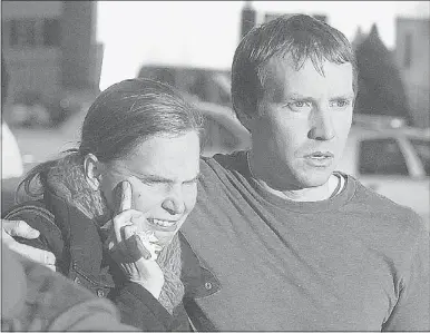  ?? Alex von Kleydorff/the Hour/the Associated Press ?? People leave the Sandy Hook Volunteer Fire House in tears after a shooting at the Sandy Hook Elementary School Friday in Newtown, Conn. A man opened fire inside two classrooms where his mother was a teacher, killing 26 people, including 20 children, as youngsters cowered in corners and closets.