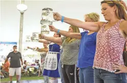  ?? ALEXIS MACKLIN/THE REPUBLIC ?? Guests compete in the stein holding competitio­n at the Arizona Center for Germanic Cultures’ authentic Old World Oktoberfes­t in Peoria on Oct. 3, 2015. The event featured German food, beer and activities.