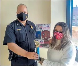  ?? COURTESY SALLY CRAGIN ?? Fitchburg Police Lt. Jeffrey Howe awards Ella Comeau of Memorial Middle School the top prize in the dog poster contest.