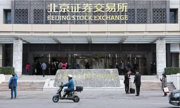  ?? — Reuters ?? Safe haven: The new Beijing Stock Exchange at Financial Street is seen in this file photo. The bearish stock market has been attributed to the flight of cash to bonds.