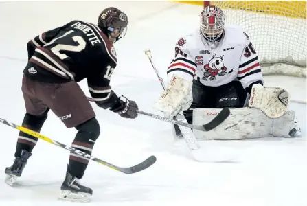  ?? CLIFFORD SKARSTEDT/EXAMINER ?? Peterborou­gh Petes centre Chris Paquette fires the puck at Niagara IceDogs goalie Stephen Dhillon during the first period of Game 1 of the OHL Eastern Conference quarter-finals Thursday night at the Memorial Centre. Game 2 is at 7:05 p.m. Saturday.