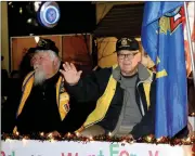  ?? Janelle Jessen/Herald-Leader ?? Members of VFW Post 1674 wave from their float.