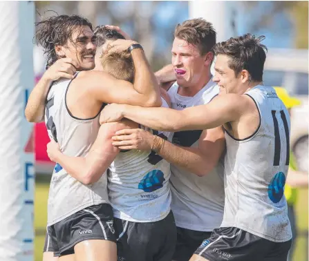  ?? Picture: TJ YELDS/NEAFL ?? The Southport spirit is evident as players flock to Dylan Fyfe after he kicked a goal.