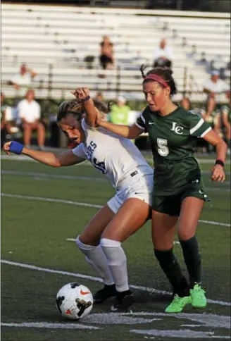  ?? JENNA MILLER — THE NEWS-HERALD ?? Gilmour’s Izzy Greene and Lake Catholic’s Kennedy Newhart vie for possession during the Lancers’ victory on Sept. 25 at Gilmour.
