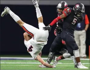  ?? Photo submitted by the Star-Telegram/STEVE NURENBERG ?? Arkansas freshman Jalen Catalon (right), playing for Mansfield (Texas) Legacy, flips Frisco Wakeland wide receiver Philip Smith during a 2017 playoff game in Frisco, Texas.