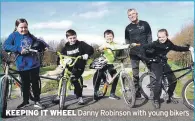  ??  ?? KEEPING IT WHEEL Danny Robinson with young bikers