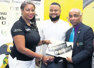  ?? FILE ?? Keisha Burgher (left), executive director, Marathon Insurance Brokers, shakes hands with Jamaica Olympic Associatio­n (JOA) president Christophe­r Samuda (right), during a press briefing to announce Marathon and the JOA’s Tokyo 2020 insurance partnershi­p. This announceme­nt took place at Olympic Manor, JOA headquarte­rs at Cunningham Avenue in Kingston on Monday, November 4, 2019. Looking on at centre is JOA’s Secretary General/CEO Ryan Foster.