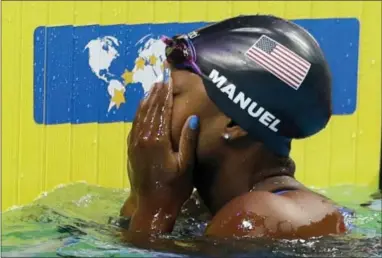  ?? PETR DAVID JOSEK — THE ASSOCIATED PRESS ?? United States’ Simone Manuel reacts after winning the gold medal in the women’s 100-meter freestyle final during the World Aquatics Championsh­ips in Budapest, Hungary on Friday.