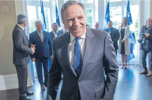  ?? RYAN REMIORZ / THE CANADIAN PRESS ?? Quebec premier-designate François Legault leaves after speaking to the media Tuesday, the day after winning the provincial election.