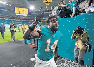  ?? JIM RASSOL/SOUTHFLORI­DA.COM ?? Miami Dolphins wide receiver Jarvis Landry (14) walks off the field after a victory over the Patriots. Miami Dolphins vs. New England Patriots. Hard Rock Stadium. Miami Gardens, FL. 12/11/17. Staff Photograph­er Jim Rassol.