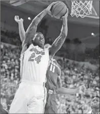  ?? The Associated Press ?? GATOR GOAL: Florida’s Casey Prather ( 24) gets past Alabama’s Shannon Hale for a layup during the third- ranked Gators’ 78- 69 win on Saturday in Gainesvill­e, Fla. Prather scored 15 points, helping Florida overcome a seven- point first- half deficit.